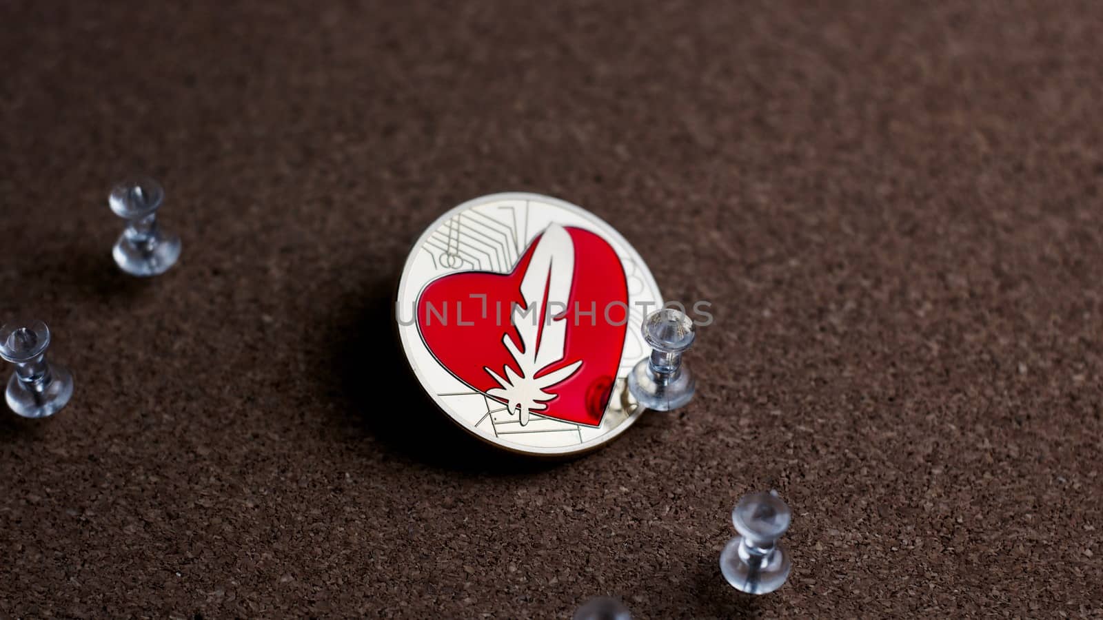 Digital currency physical gold feather coin. Office cryptocurrency concept.