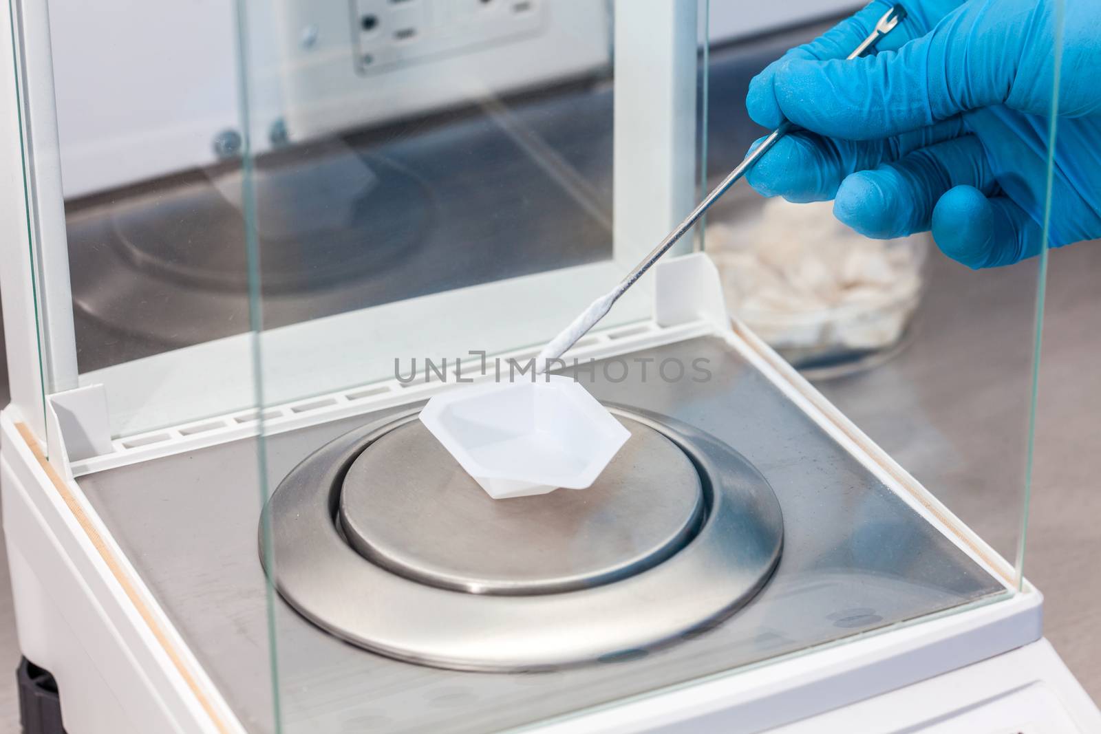 Scientist using an analytical balance at laboratory