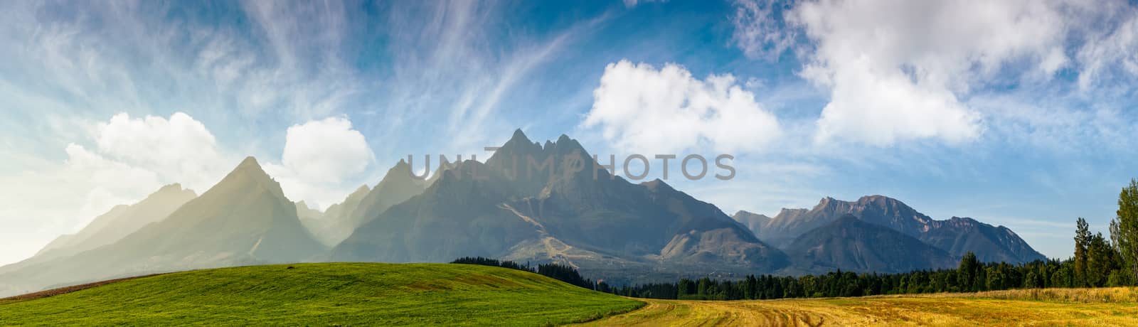 rural fields near Tatra Mountains in summer time by Pellinni