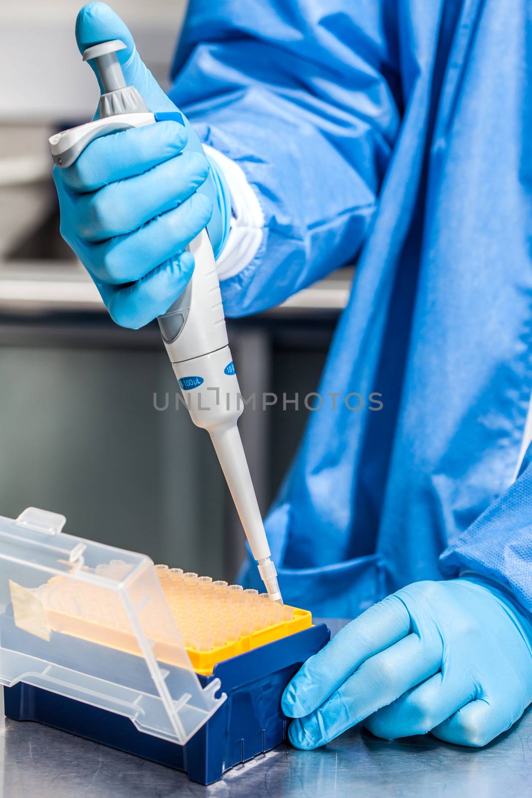 Scientist attaching a disposable tip to a micropipette