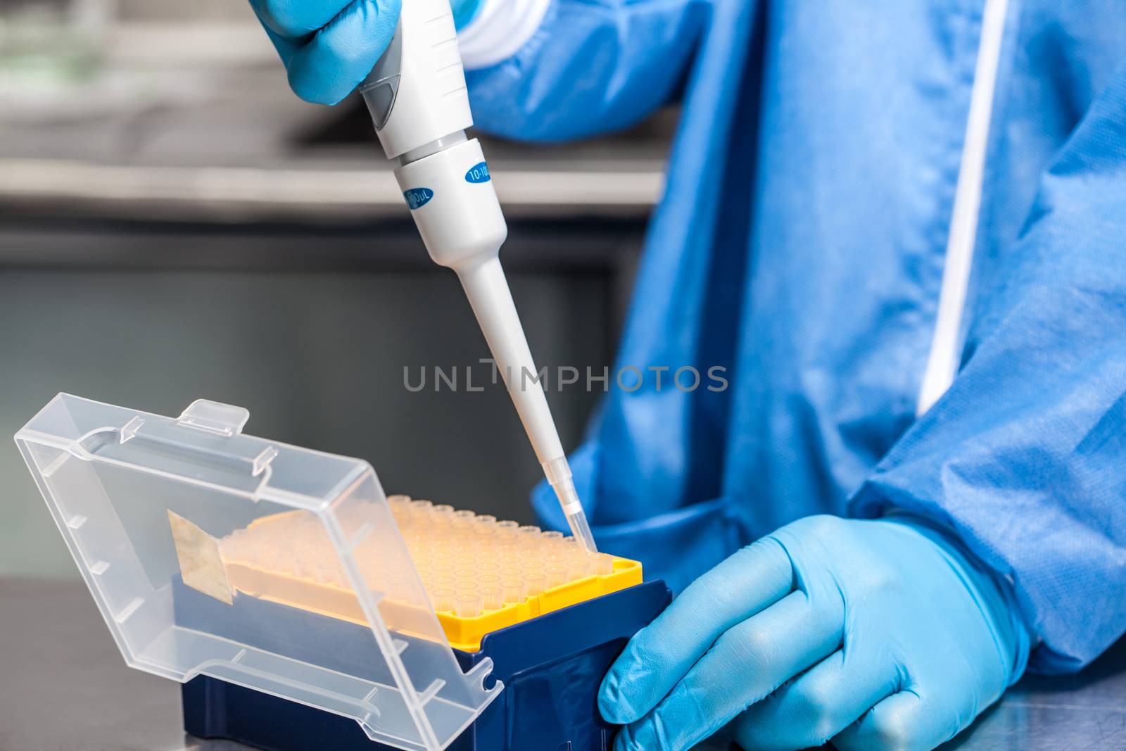 Scientist attaching a disposable tip to a micropipette