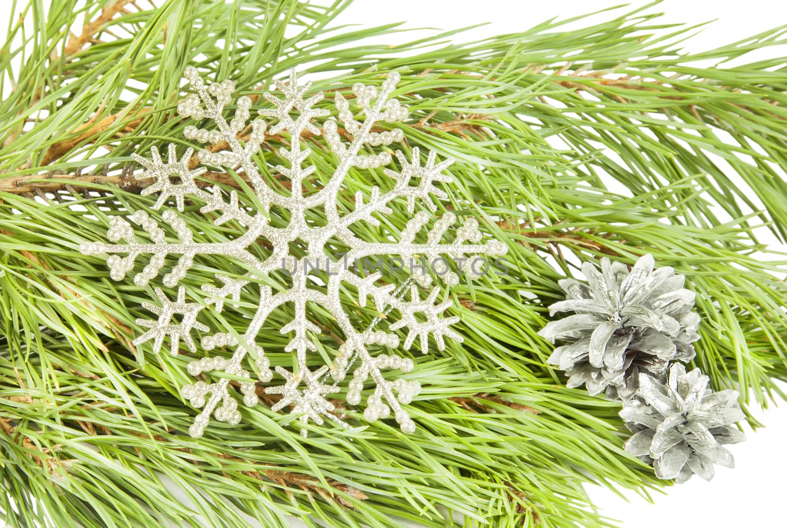 Artificial new year snowflake on fir tree branch background
