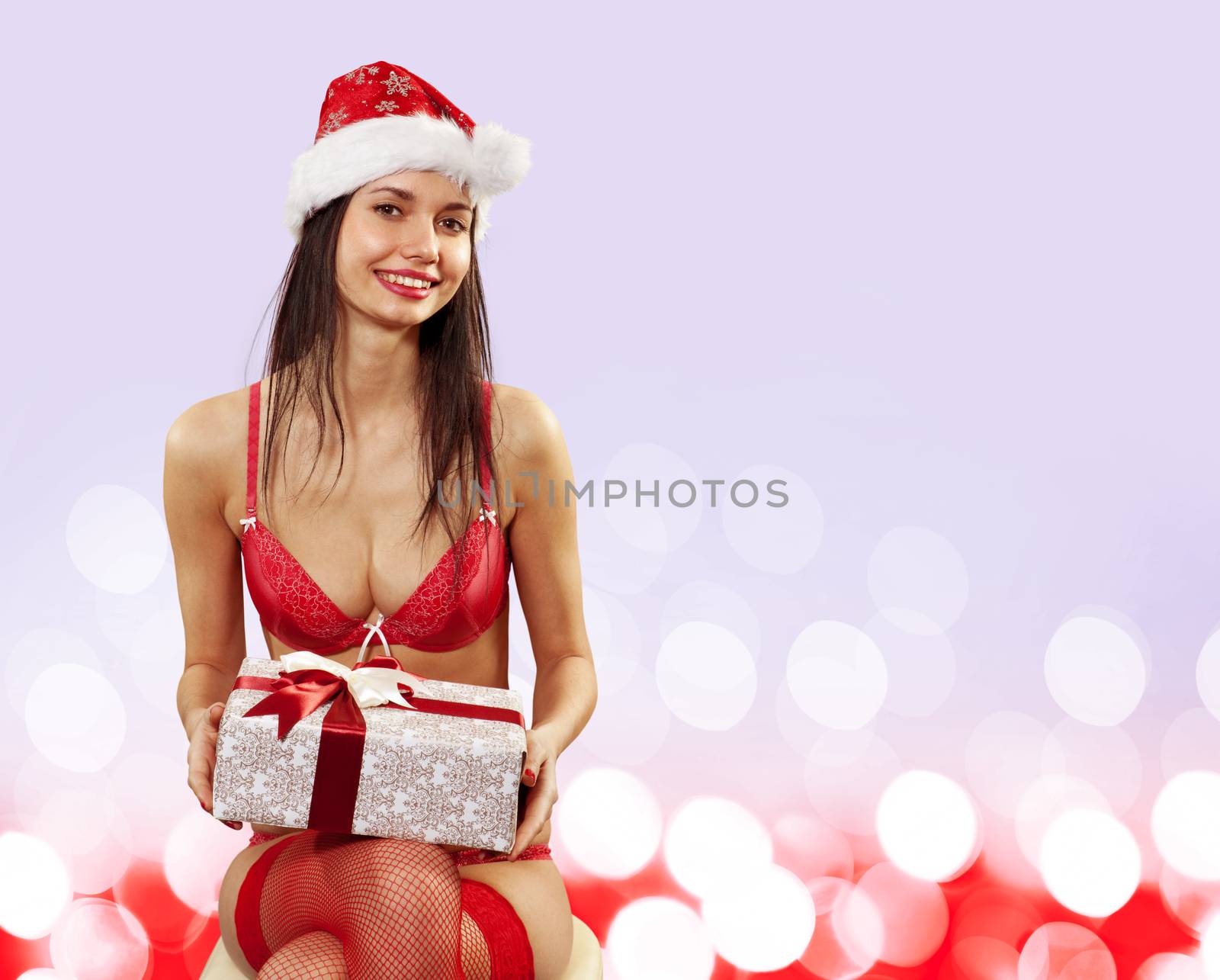 Beautiful Santa girl in red lingerie with gift box