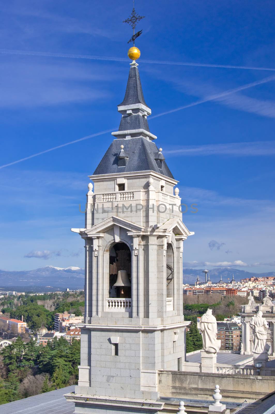 Bell tower of Santa Maria la Real de La Almudena cathedral with Madrid city and Guadarrama mountains on background, Spain