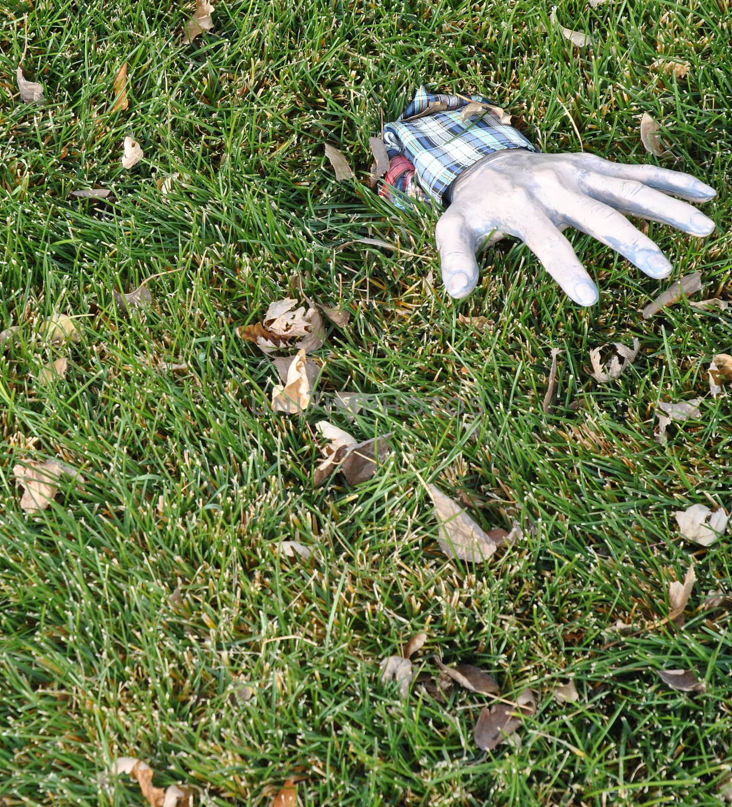 Halloween hand reaching from the grave underground.