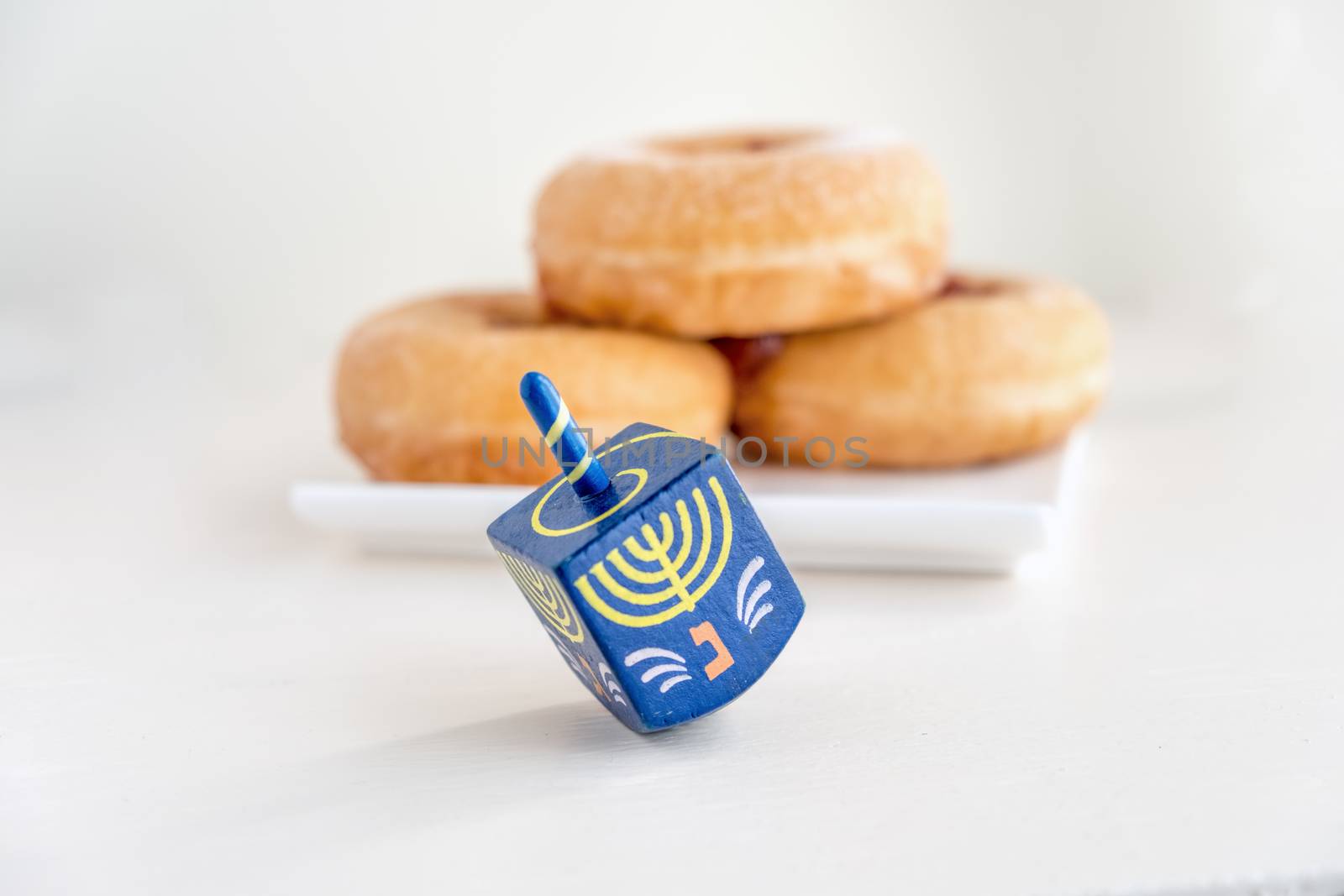 The Symbols of Hanukkah - sufganiyot and sevivon