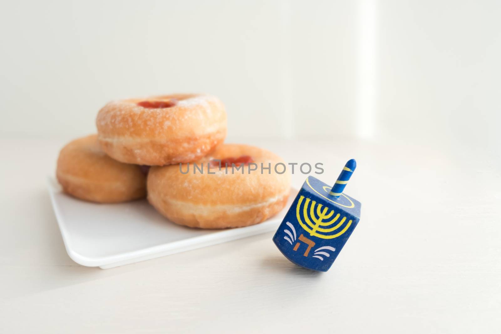 The Symbols of Hanukkah - sufganiyot and sevivon