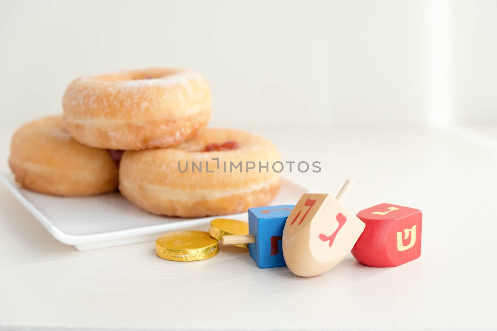 The Symbols of Hanukkah - sufganiyot, chocolate coins and sevivon