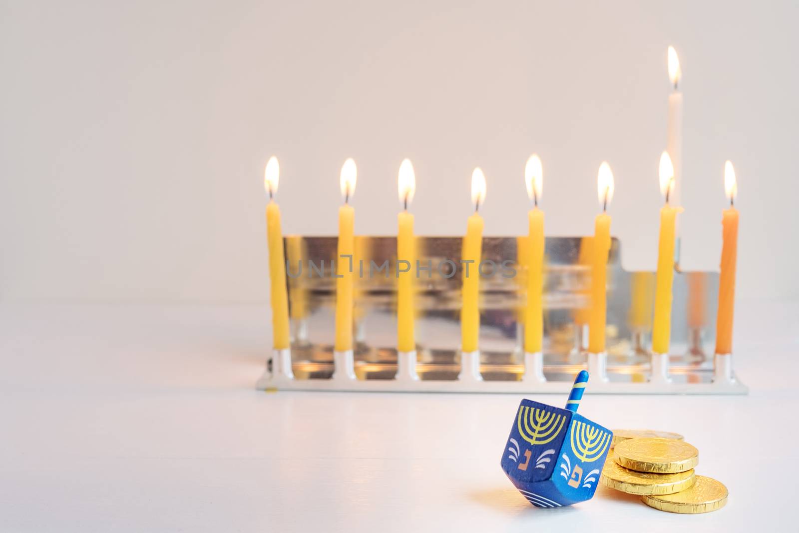 The Symbols of Hanukkah - nine-branched mehorah Hanukiah , chocolate coins and sevivon