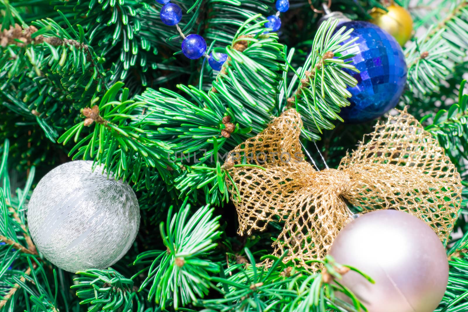 New Year coniferous tree decorated with Christmas ornament, balls, dolls