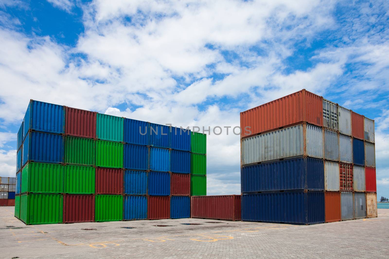 container box loading at yardContainer handling. Container truck picking up container at yard. Port logistics container yard operation.