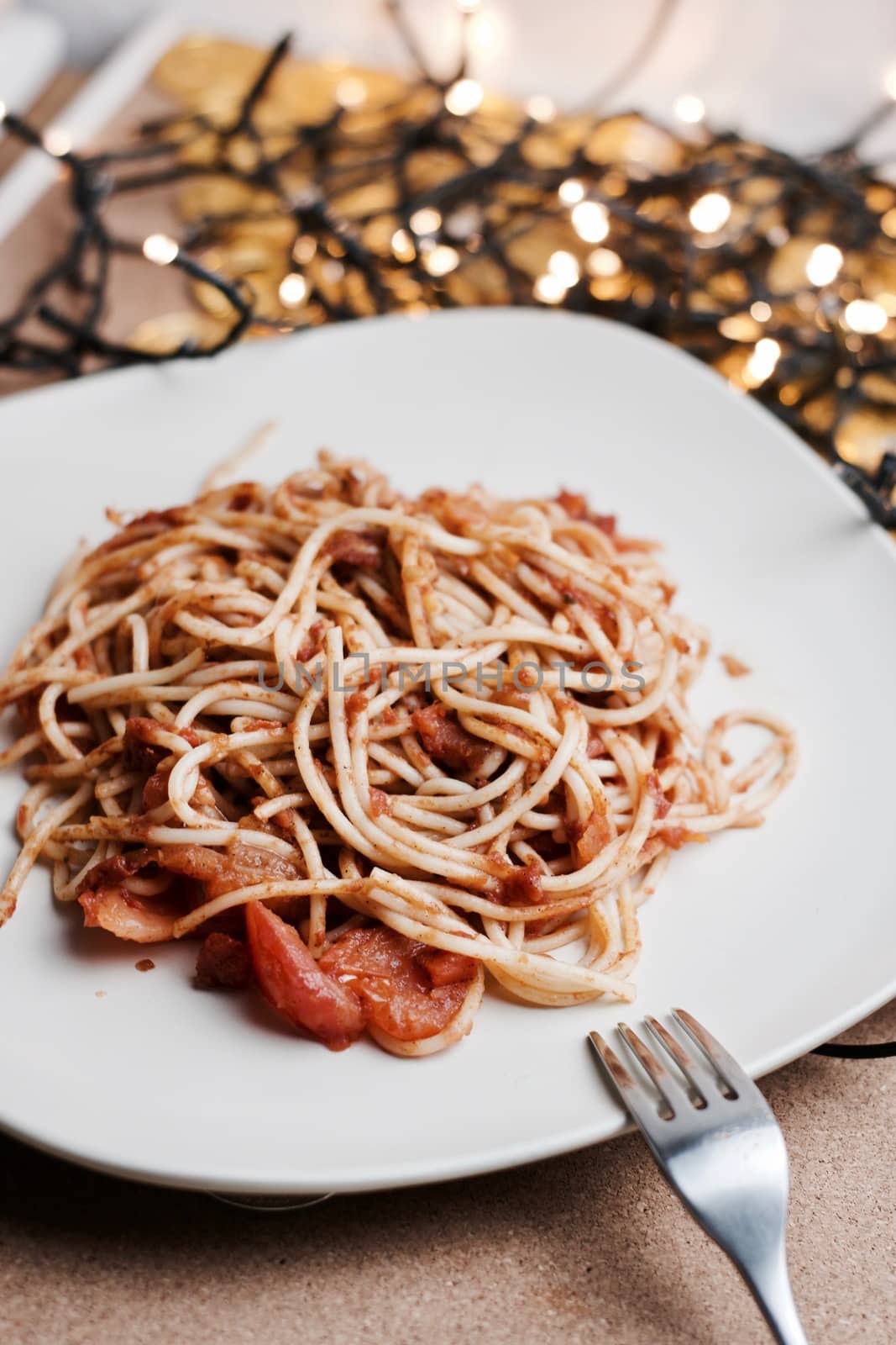 Italian tasty and fresh pasta on white plate. Christmas food concept.