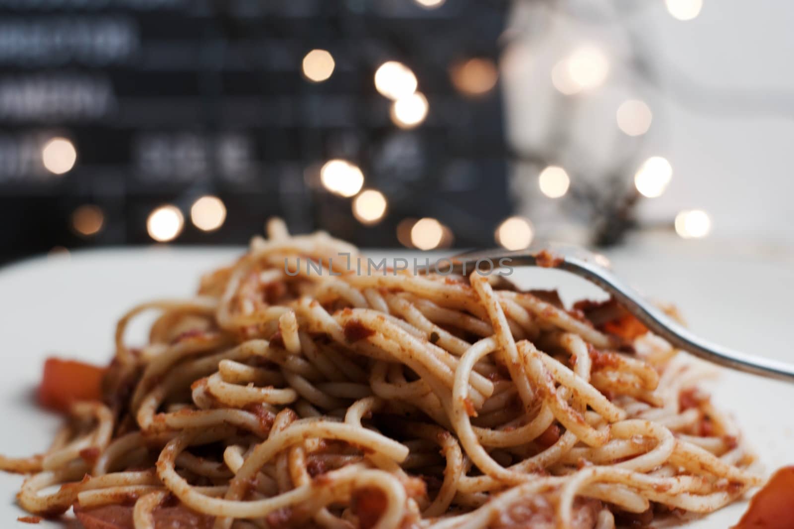 Italian tasty pasta with tomatoes on a silver fork. Christmas concept.