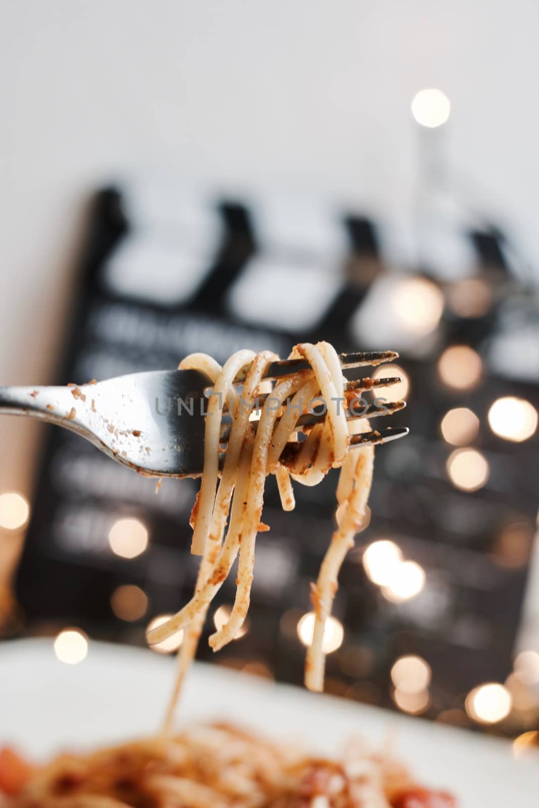 Italian tasty pasta with tomatoes on a silver fork. Christmas concept.