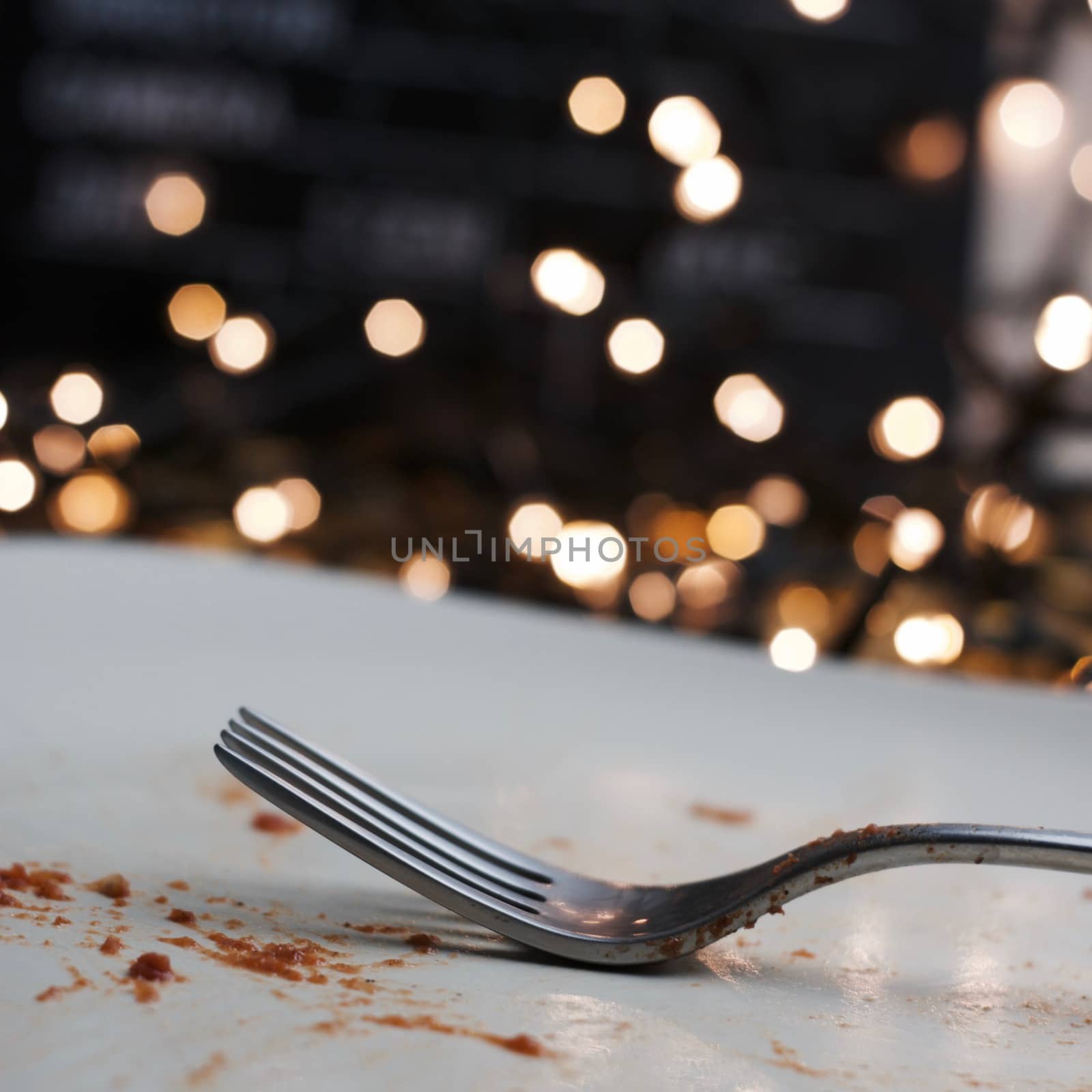Dirty silver fork on dirty white plate. Christmas food concept.