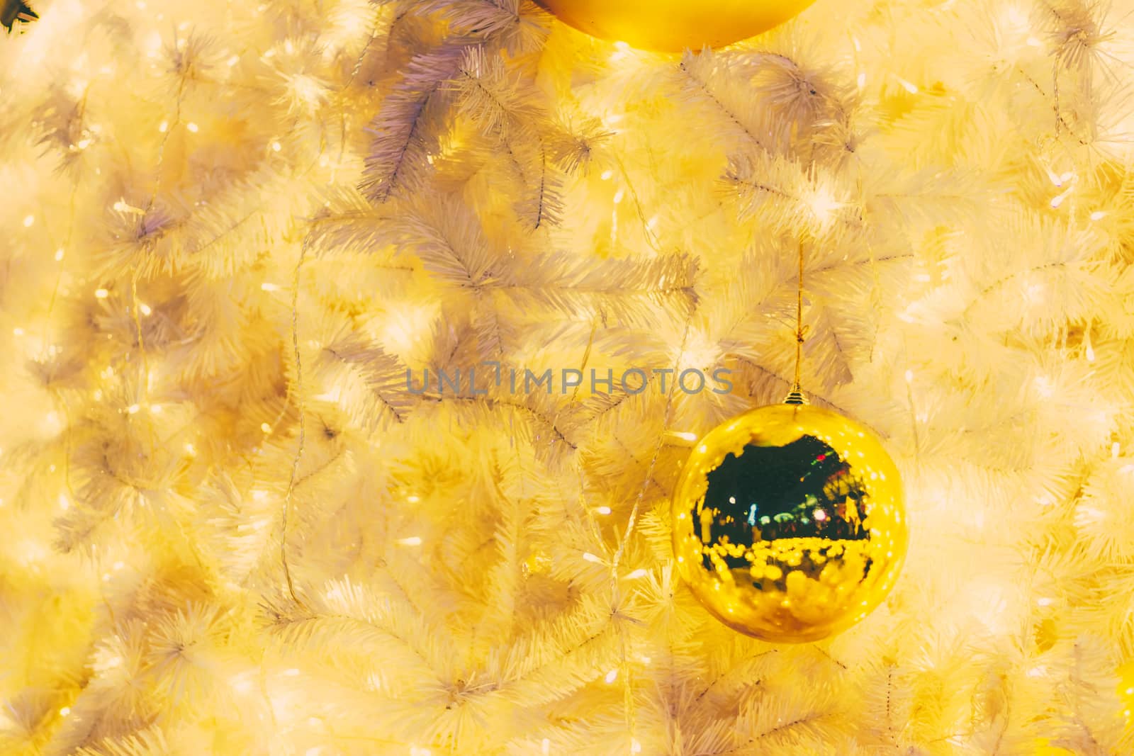 Yellow christmas ornaments on tree