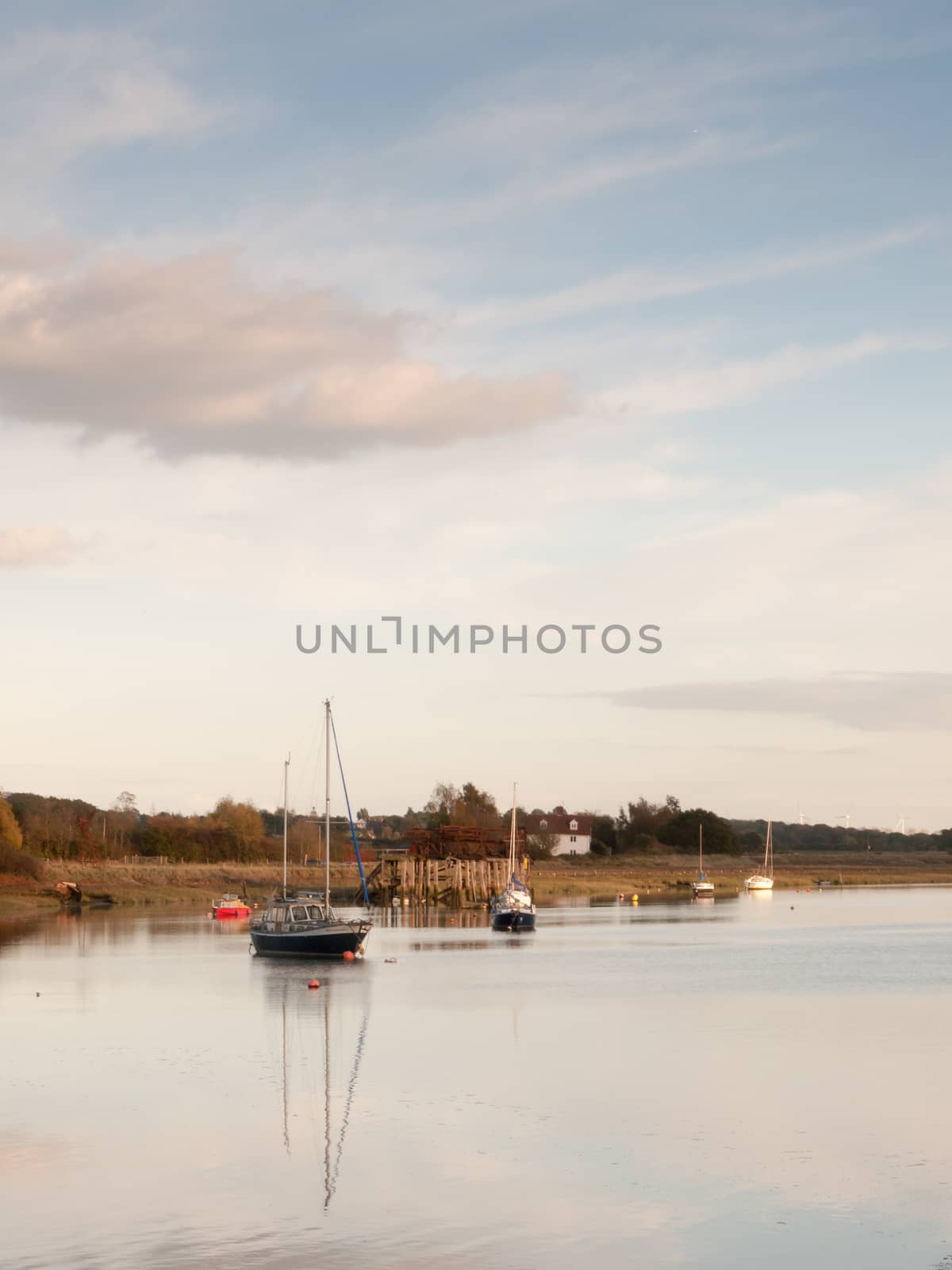 boats in harbour masts landscape river lake water surface clear; essex; england; uk