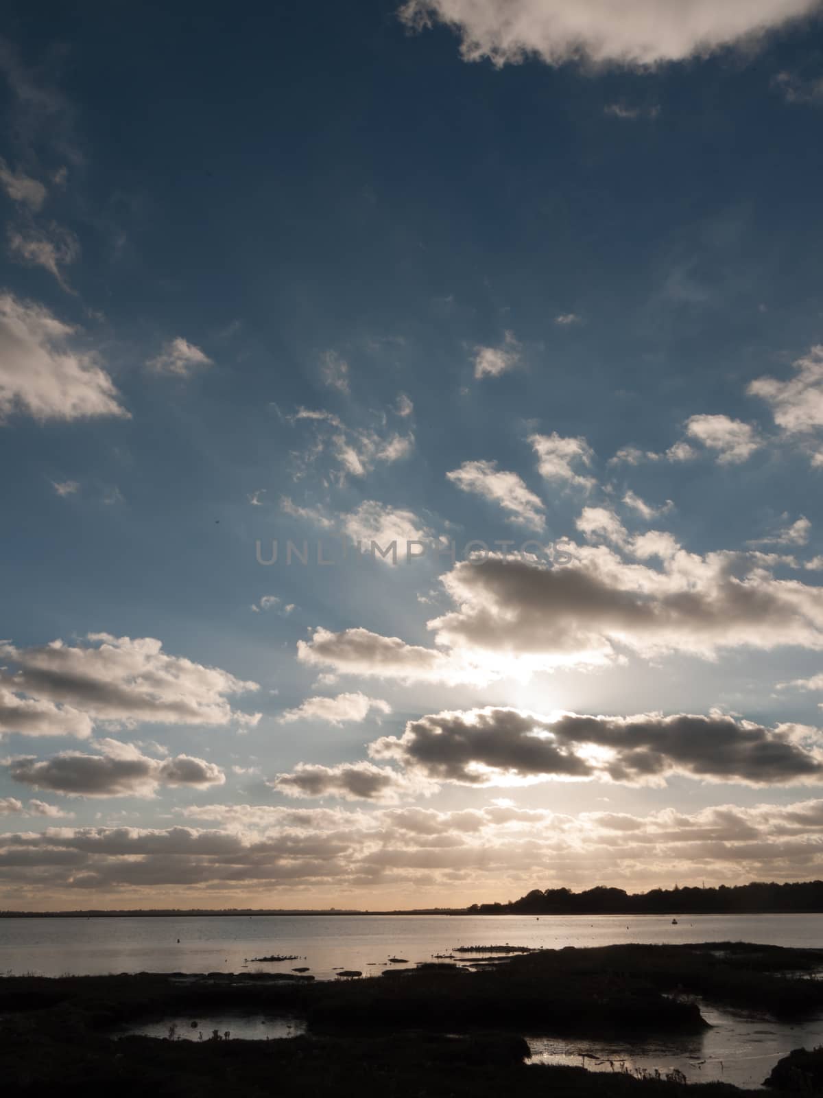 beautiful sunset over harbour coast sea bay clouds silhouette landscape; essex; england; uk