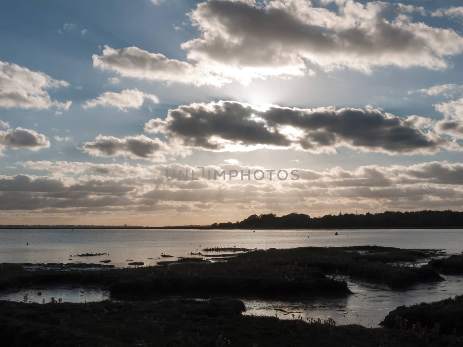 beautiful sunset over harbour coast sea bay clouds silhouette landscape; essex; england; uk