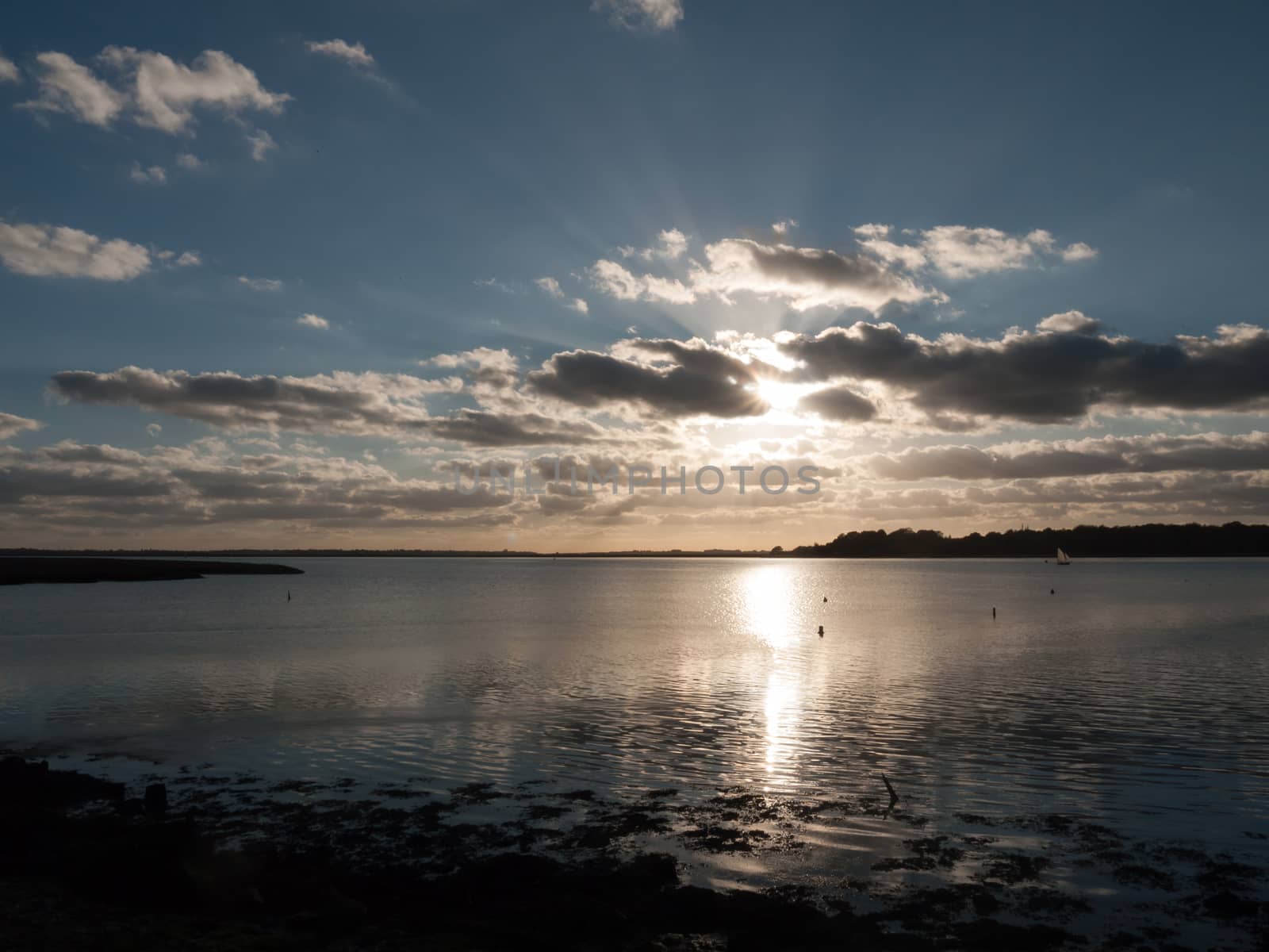 beautiful sunset over harbour coast sea bay clouds silhouette landscape; essex; england; uk