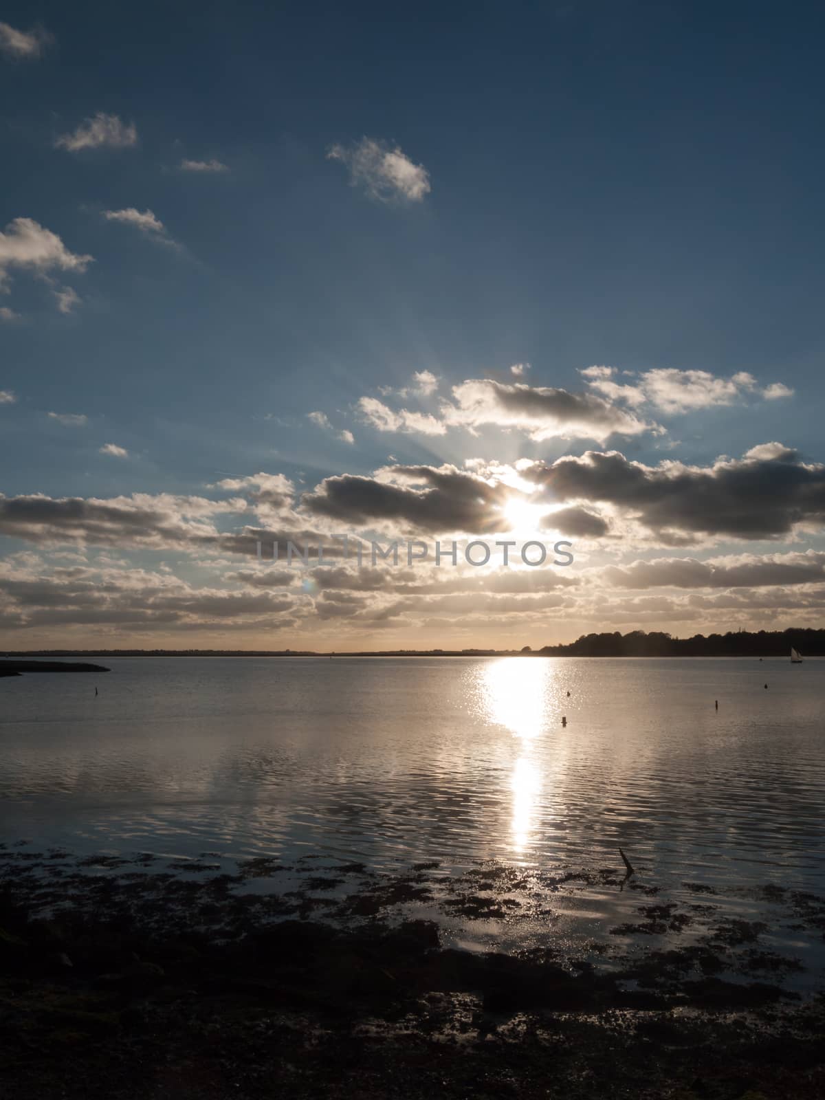 beautiful sunset over harbour coast sea bay clouds silhouette landscape; essex; england; uk