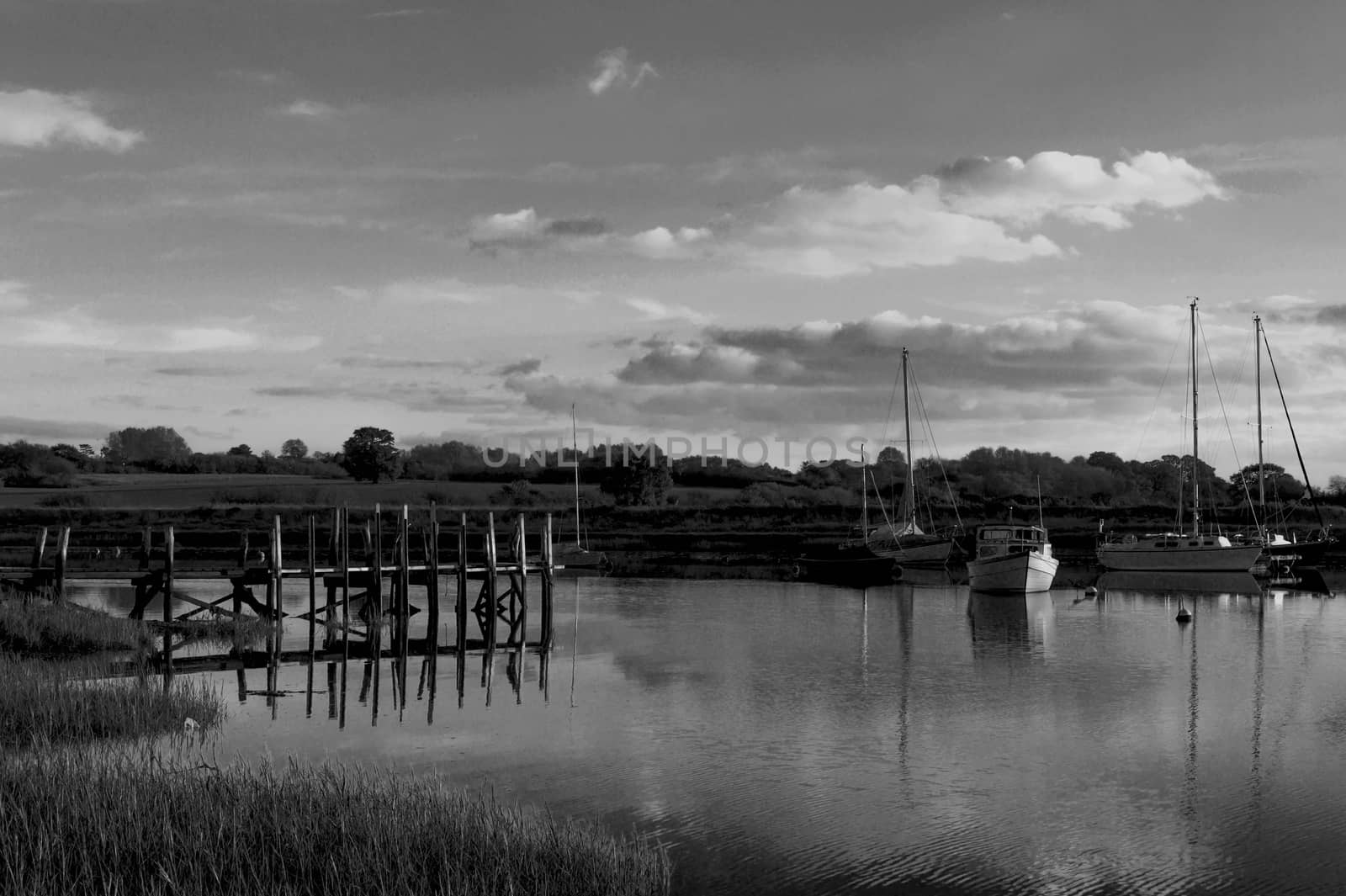 beautiful black and white harbour scene outside soft light boats moored; essex; england; uk