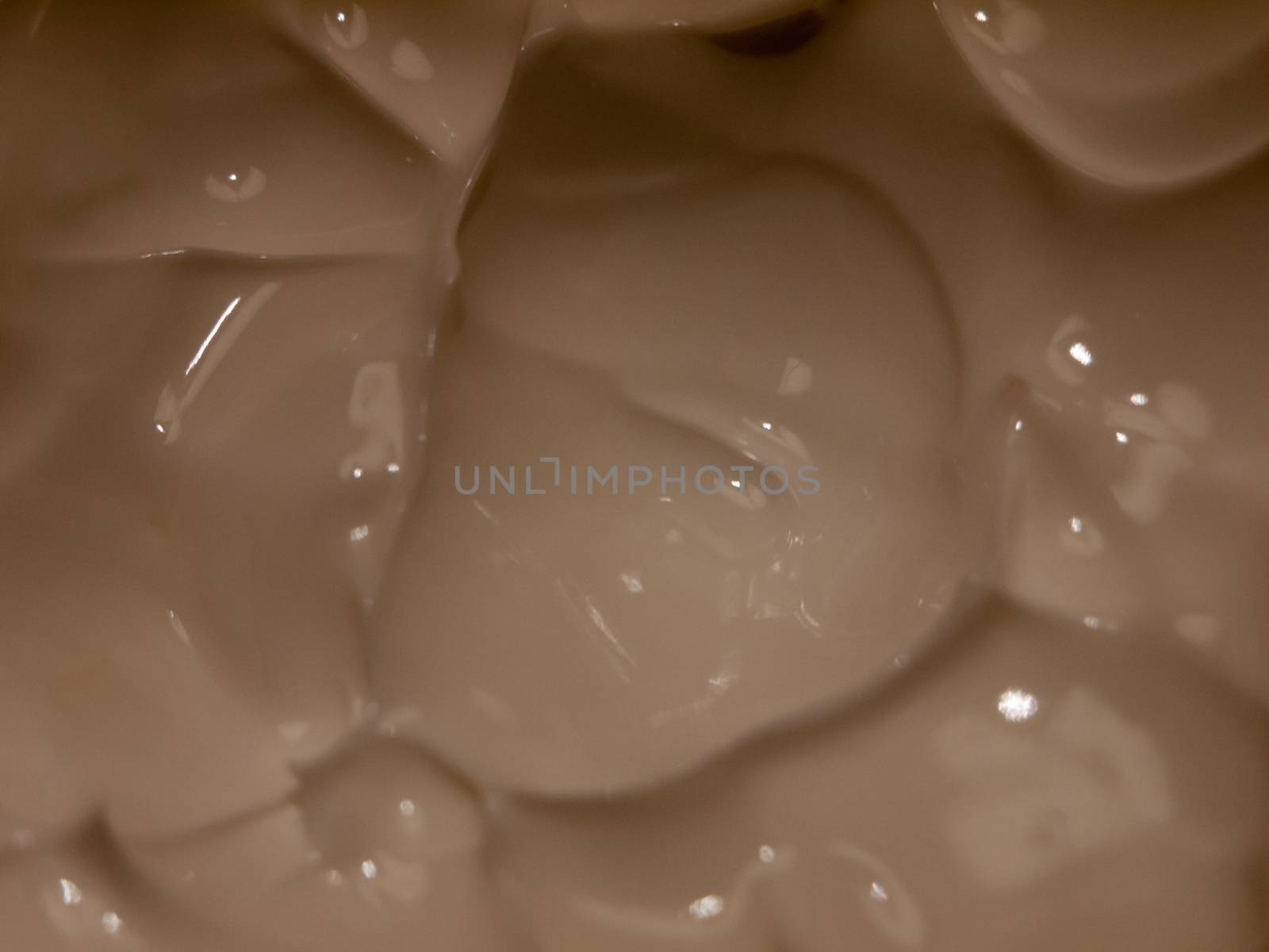 close up of white cream moisturizer inside glass tub; essex; england; uk