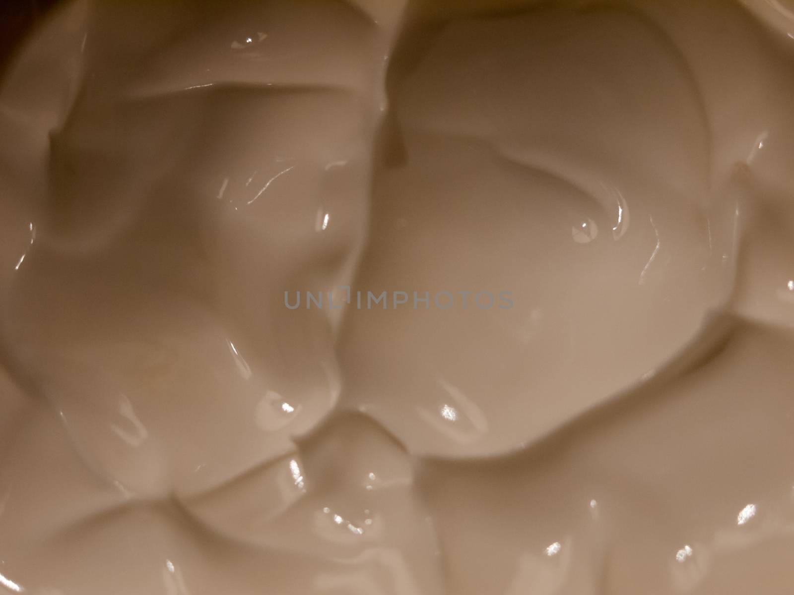 close up of white cream moisturizer inside glass tub; essex; england; uk