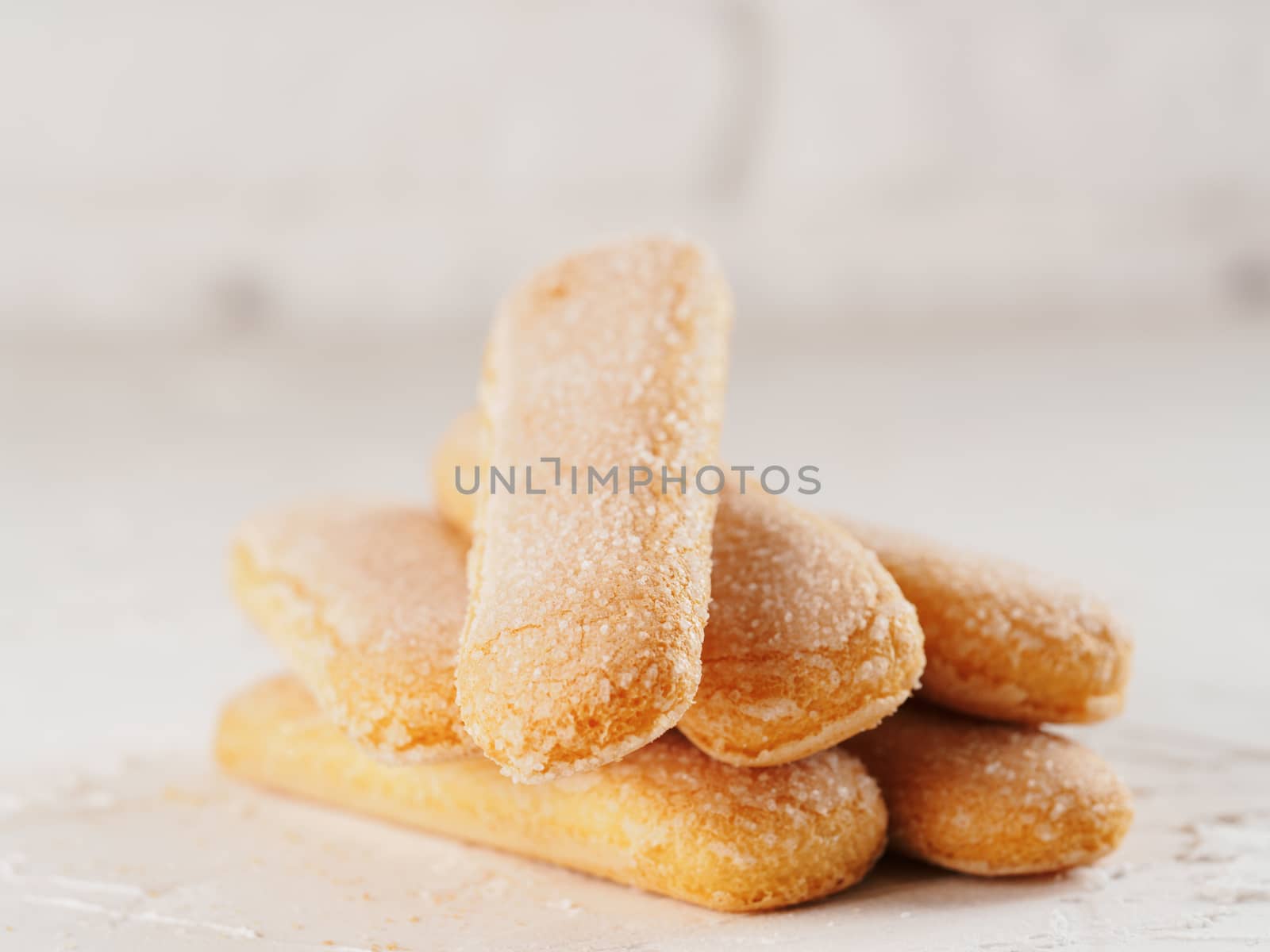 Close up view of ladyfinger biscuit cookie on white concrete background. Italian cookie savoiardi.