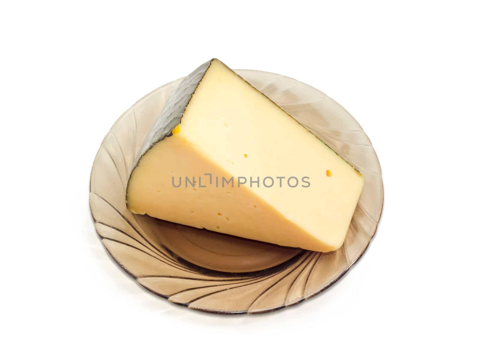 Piece of the hard cheese on the dark glass saucer on a light background
