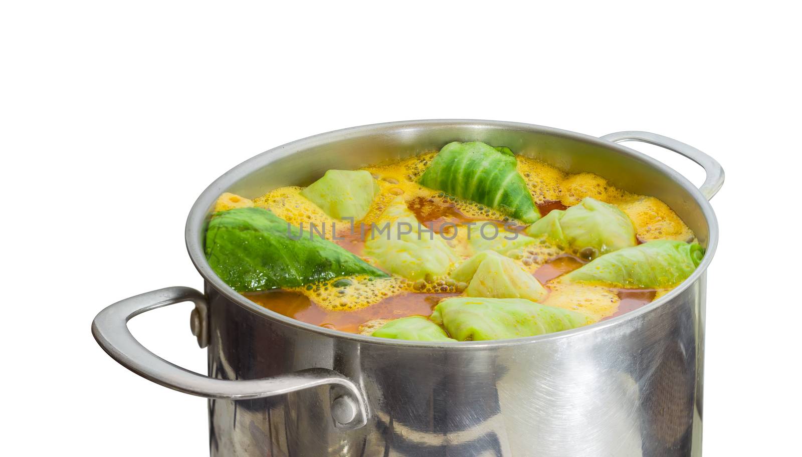 Fragment of the large stainless steel saucepan with stuffed cabbage rolls in boiling sauce during cooking on a light background
