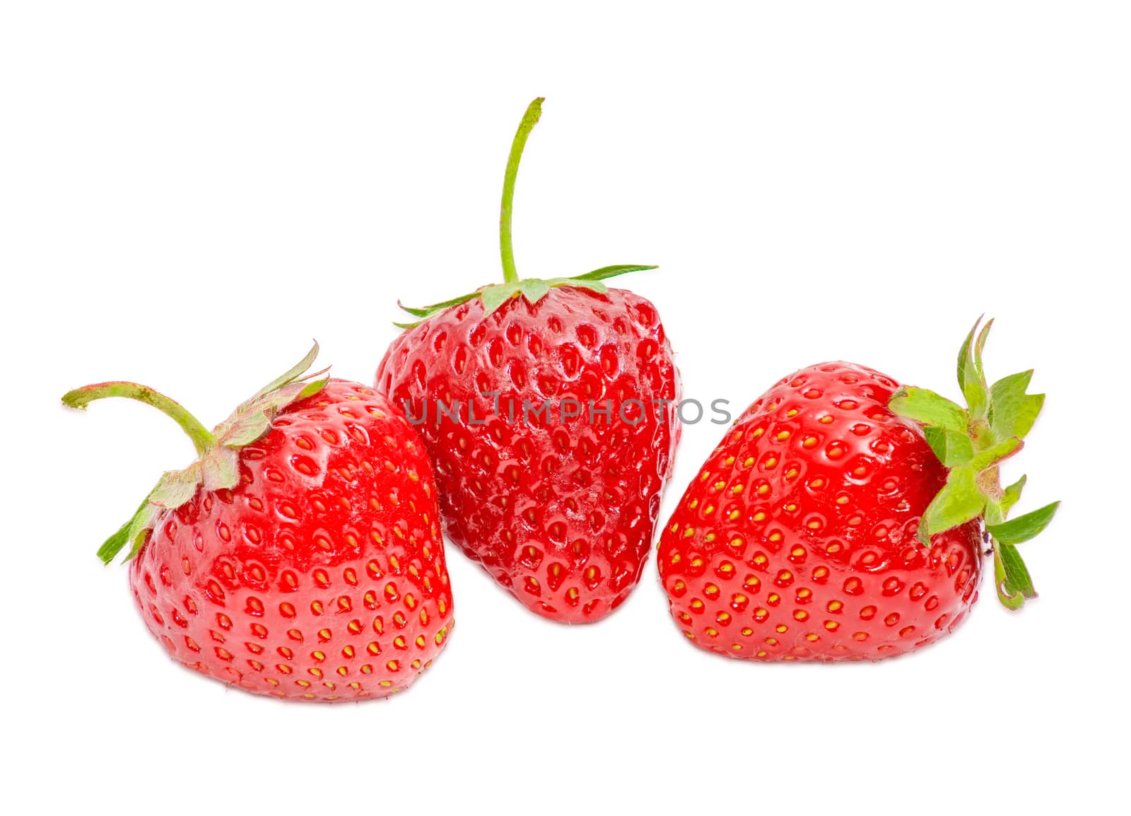 Three ripe fresh berries of the garden strawberry closeup on a light background
