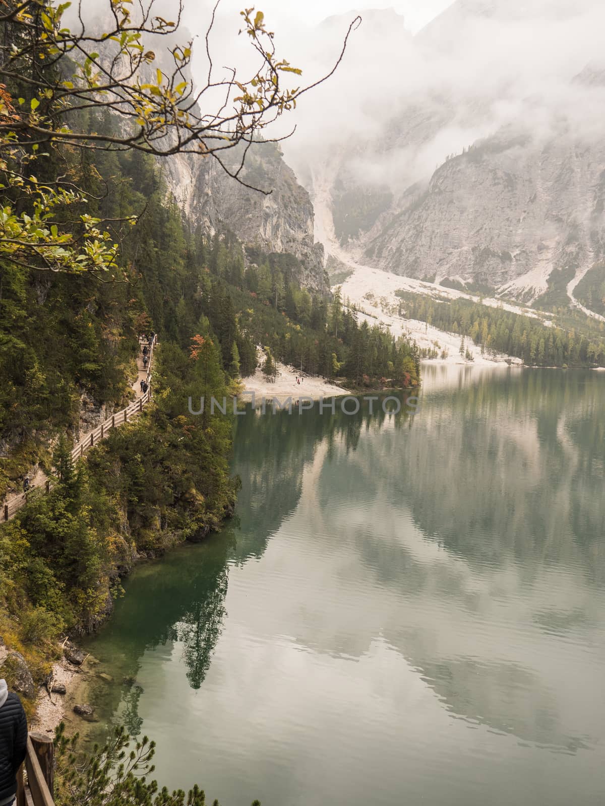 View to beautiful calm lake in forest in mountains.