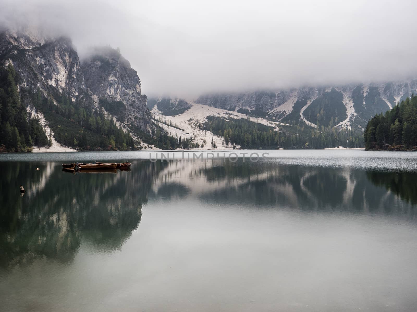 View to beautiful calm lake in forest in mountains.