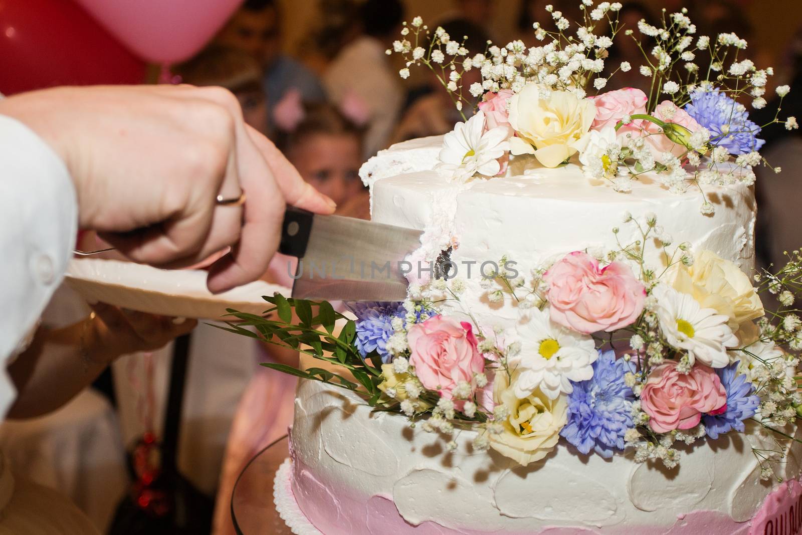 elegant pretty young bride and groom cut the wedding cake by 3KStudio