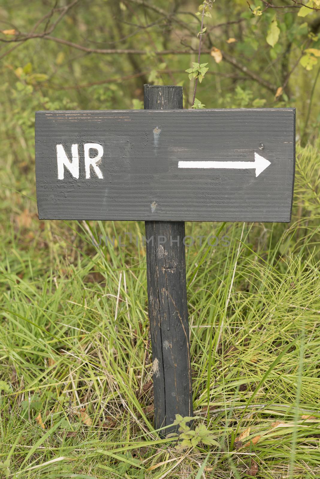 Grey wooden sign with the abbreviated Dutch text number in white color
