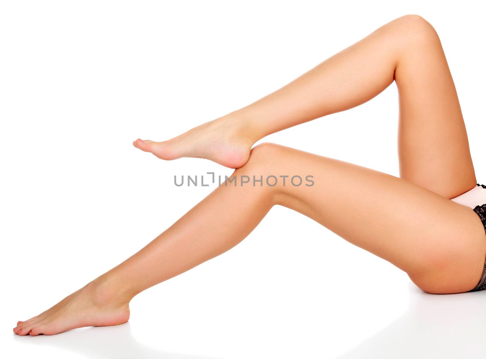 Closeup shot of beautiful long female legs isolated on white background