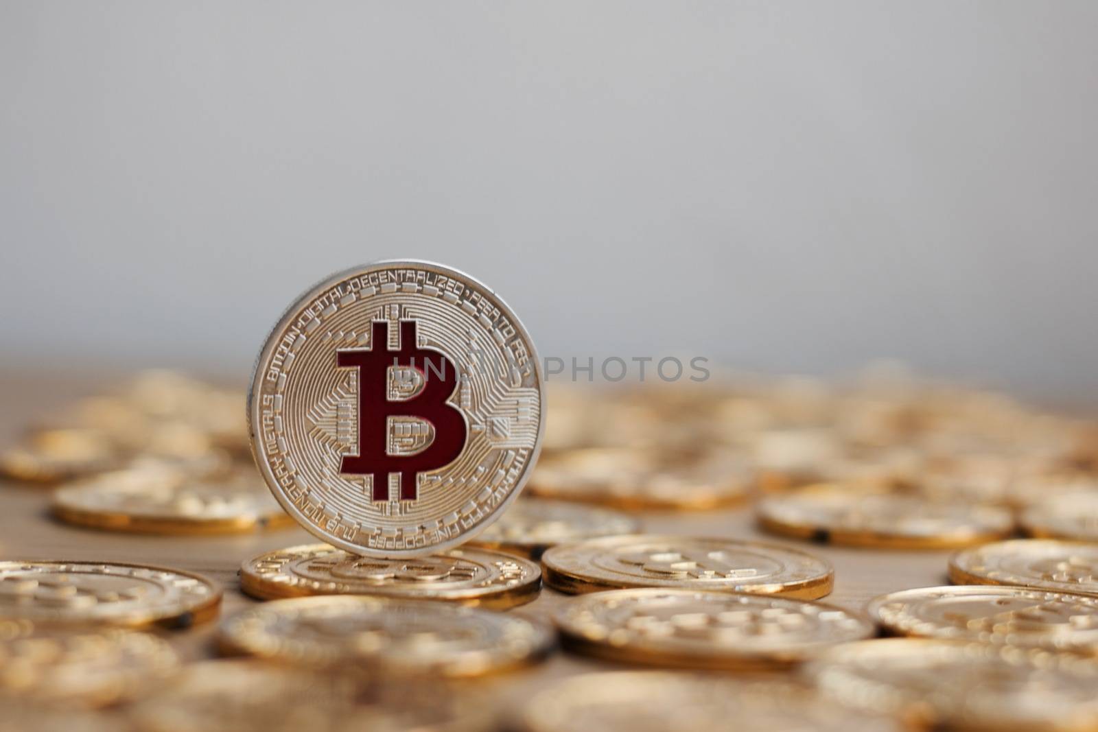 Digital currency physical bitcoin coin. Gold background coins concept.