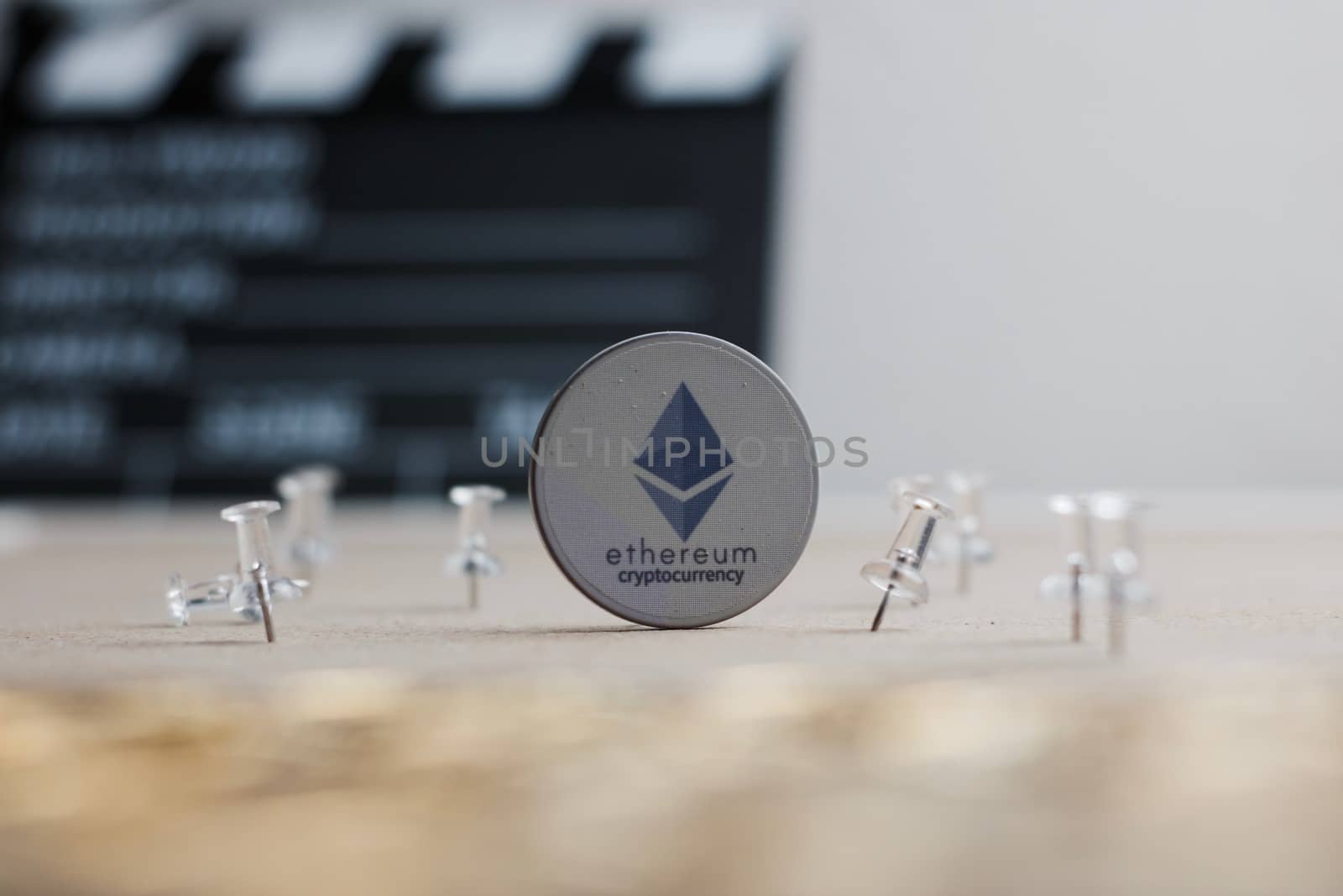 Digital currency physical ethereum token. Cryptocurrency cinema concept.