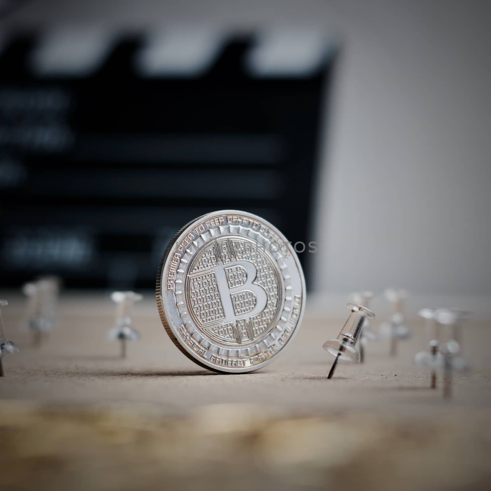 Digital currency physical metal bitcoin coin. Cryptocurrency cinema concept.