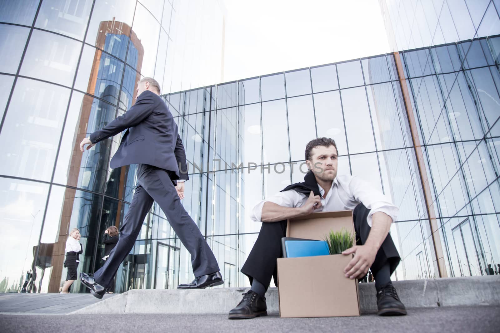 Fired businessman sitting on street by ALotOfPeople