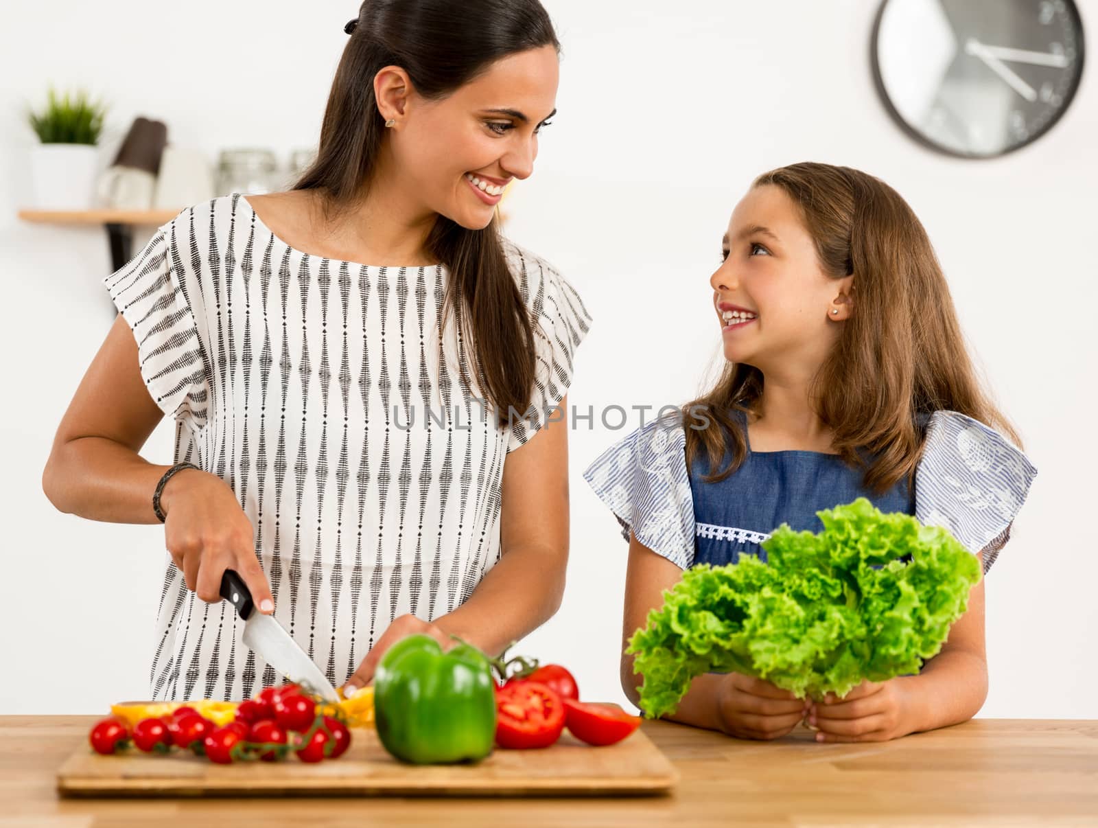 Shot of a mother and daughter having fun in the kitchen