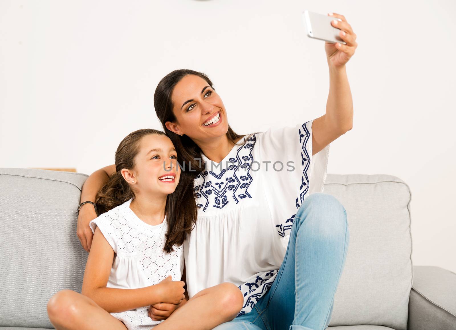 Beautiful Mom and Daughter at home making a selfie