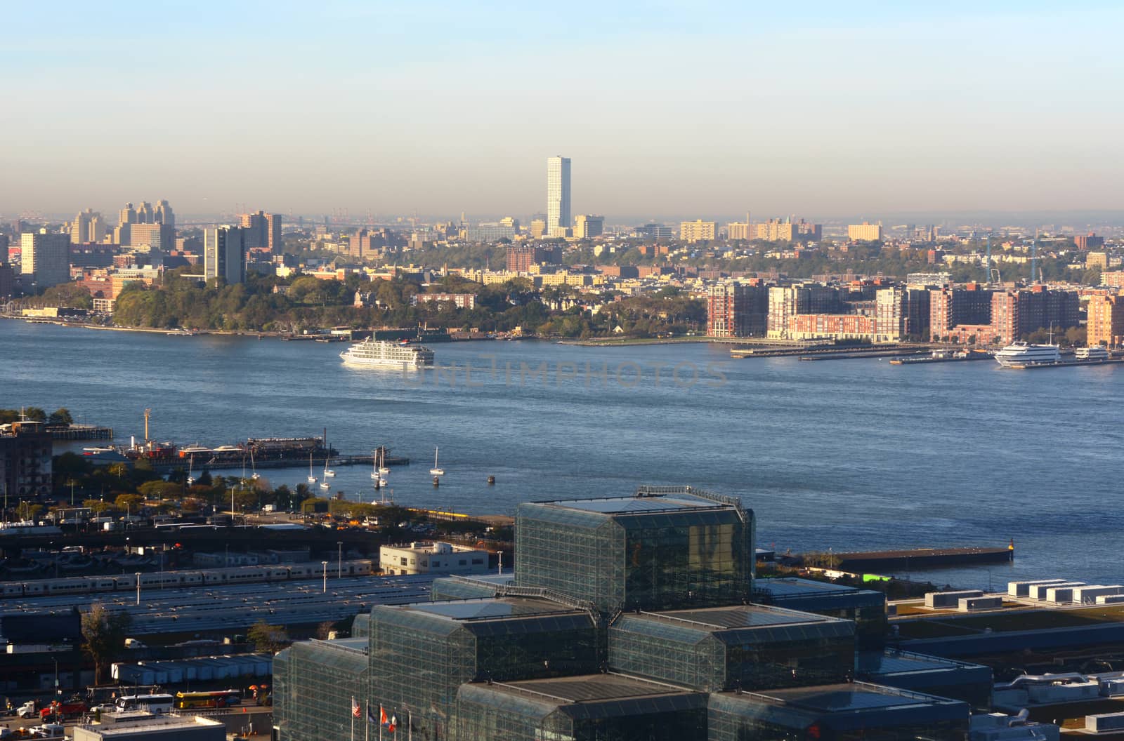 View from Manhattan in New York City, across the Hudson to New Jersey. A small ferry sails down the river, past Hoboken.