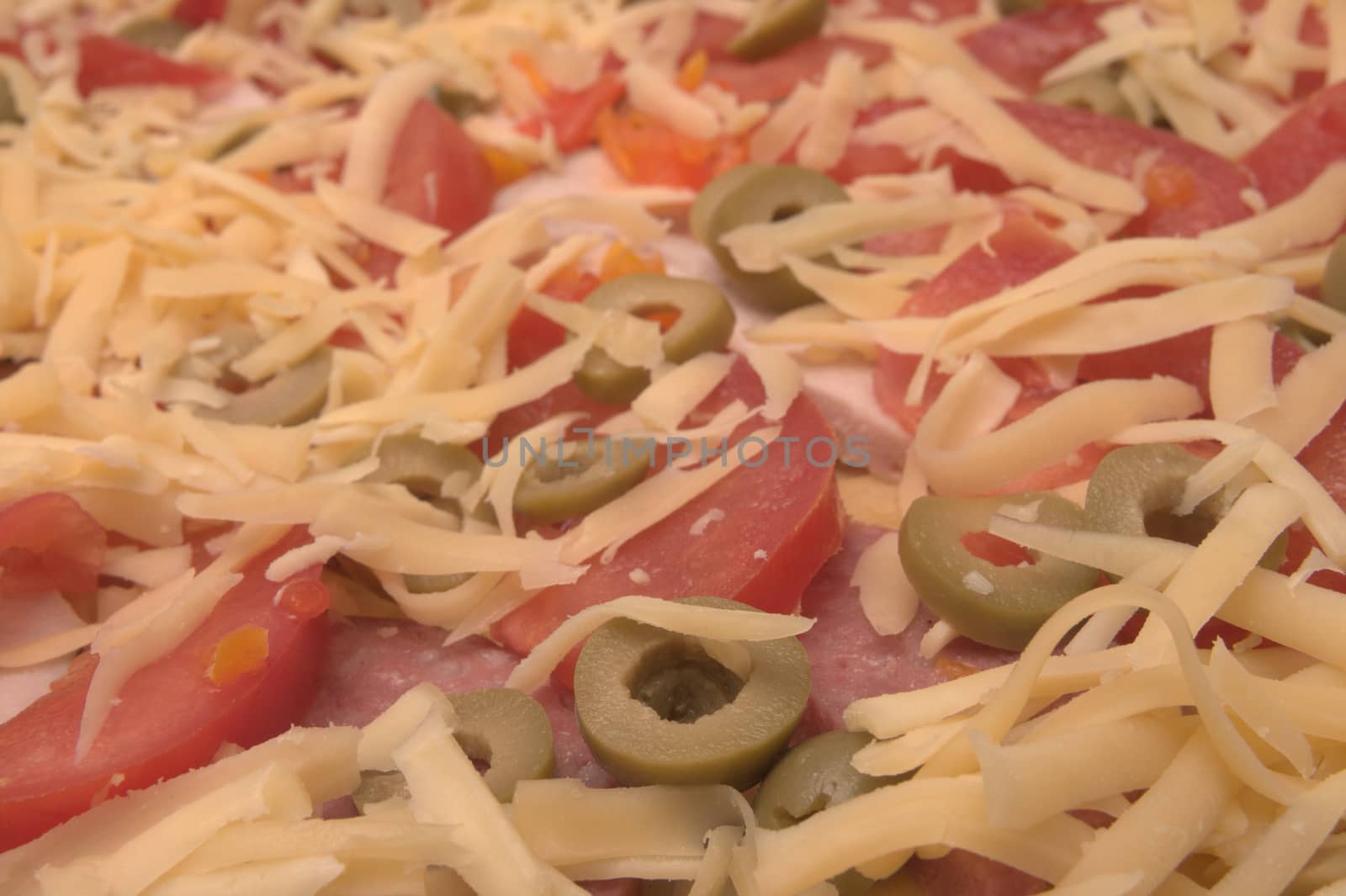 Backgroung made of white grated cheese, tomatoes,olives by alkorphoto