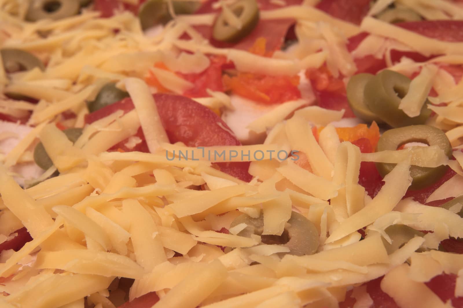 Backgroung made of white grated cheese, tomatoes,olives