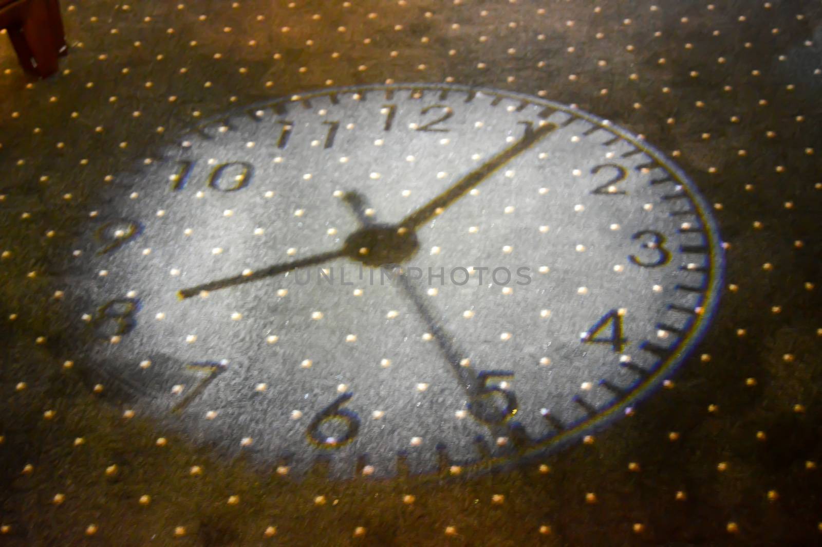 Light beam of a clock on a lounge mat