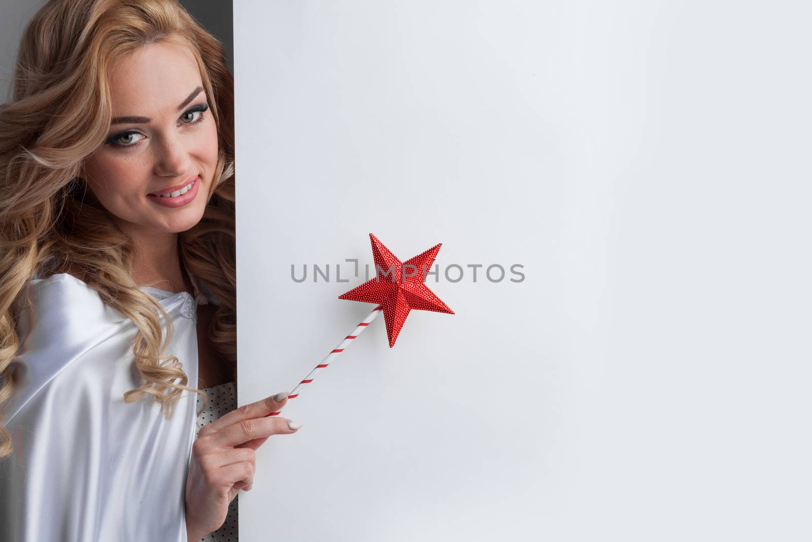 Fairy woman with magic wand with star pointing at white background