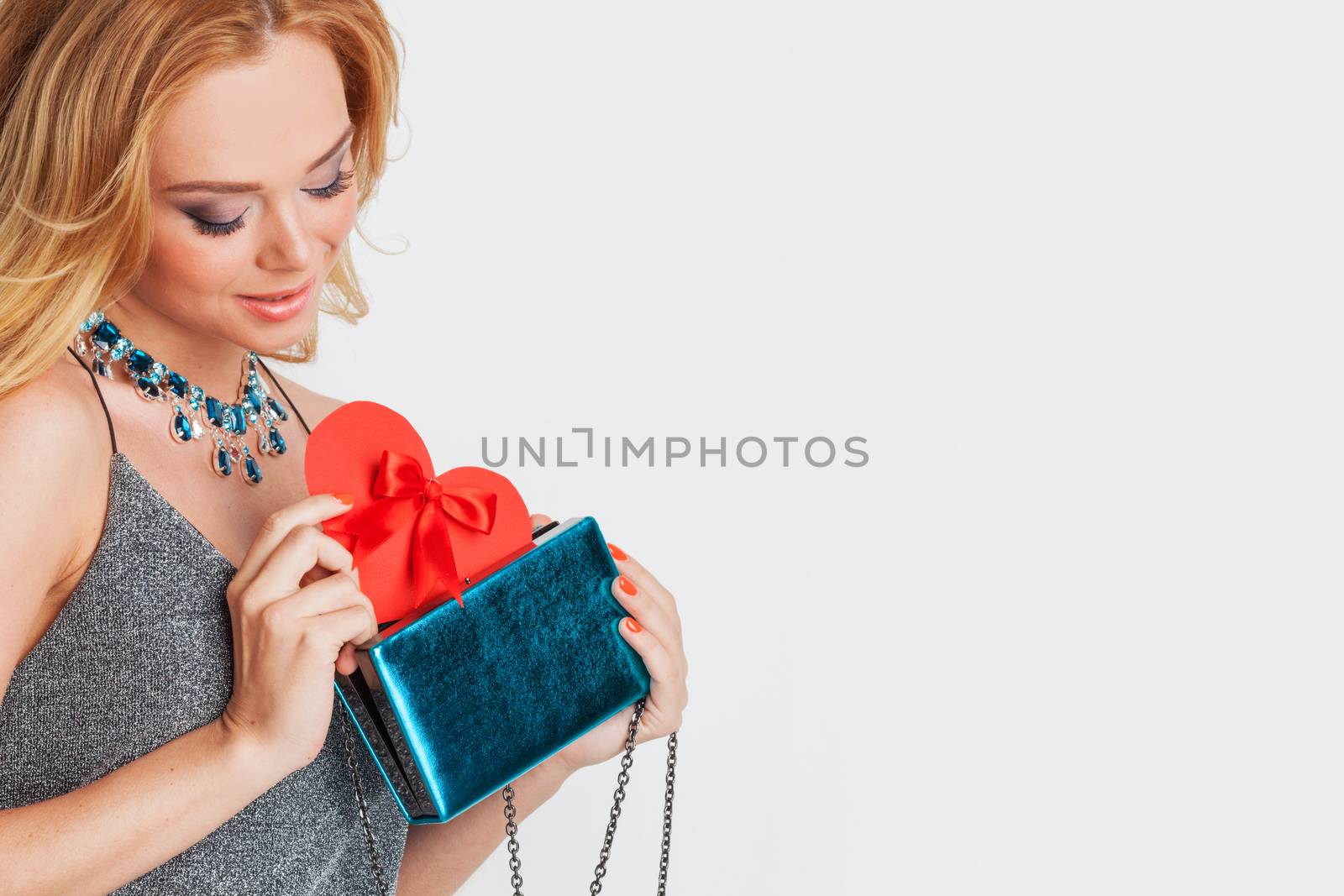 Portrait of glamorous woman holding red paper heart, valentine day concept