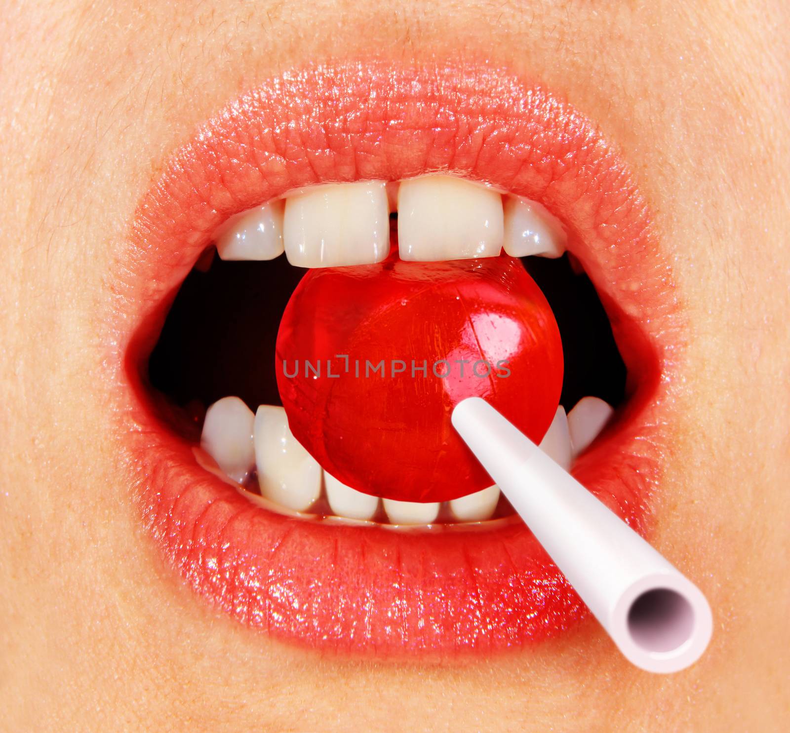 part of a woman's face, close up of lollipop in mouth